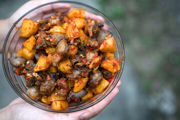 a bowl of sambal from chicken liver and potato wedges