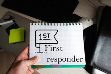 First responder word on notebook holding man against desktop.