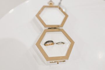 a white wooden box for wedding rings on the table
