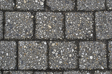 A close up of a brick walkway with a white and black background.