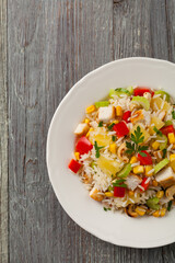 Salad with rice, chicken, peanuts and vegetables. Top view.