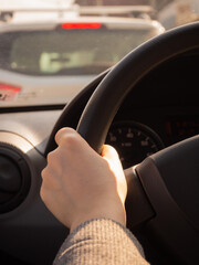 traffic jam. a woman's hand on the steering wheel. sunny day