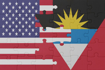 puzzle with the national flag of antigua and barbuda and united states of america. macro