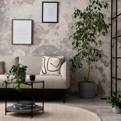 The stylish compostion at living room interior with design gray sofa, coffee table, plant, hanger, lamp and elegant personal accessories. Loft and industrial interior. Mock up poster. Template.