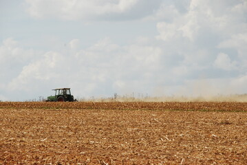Fototapeta premium Tractor in autumn at harvest work