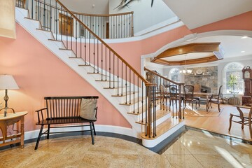 Obraz premium Two-story house, featuring a staircase connecting the ground floor to the second story