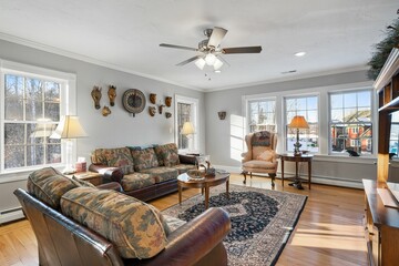 Modern living room with a comfortable seating area with hanging decorations and a large window