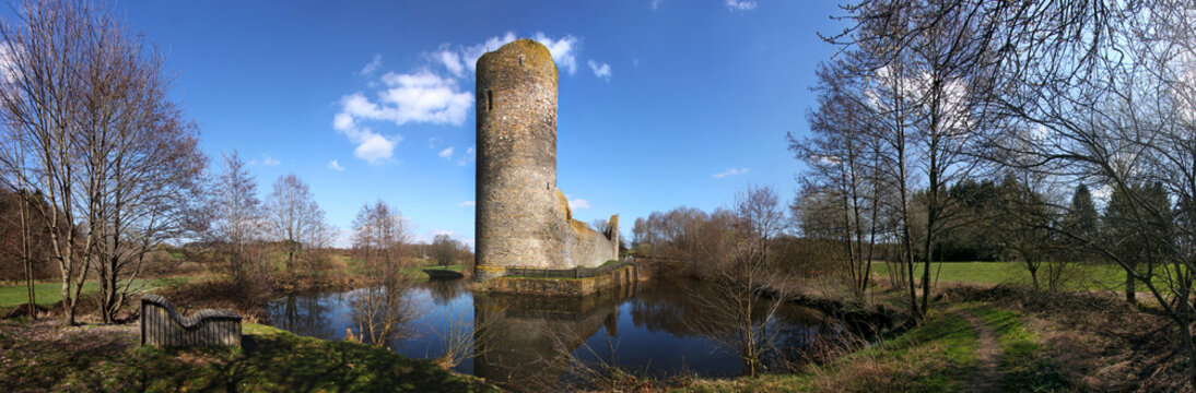 Medieval ruin of Baldenau castle with its tower and moat in early spring