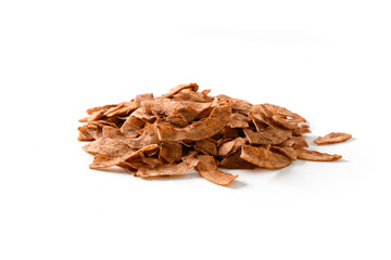 Coconut chips pile with cinnamon powder isolated on white background. Vegan sugar free dessert or snack. Close up. Snack from packet add to garnish your dessert.