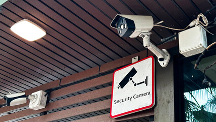 View of security camera and security sign which surrounded by dirty dust environment