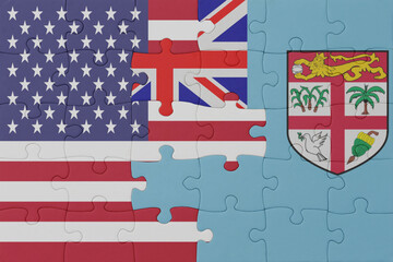 Fototapeta premium puzzle with the national flag of Fiji and united states of america. macro