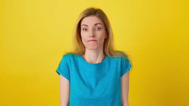 Confusion, shame and young woman spreading hands say oops ouch oh omg i am so sorry. Shy female lady, uncertain emotion with doubt problem, hand gesture with mockup in studio on yellow background