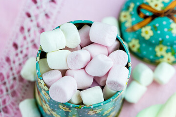 Close-up of colorful marshmallows in a round box top view