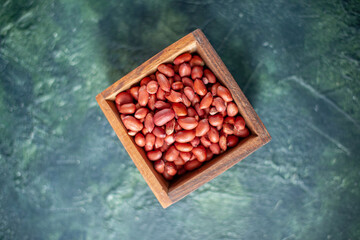 top view peeled clean peanuts on dark-blue background shell nut photo walnut peanut color snack cips - obrazy, fototapety, plakaty