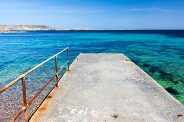 Jetty into azure blue Mediterranean Sea