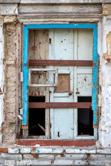 empty windows of a damaged house in Ukraine
