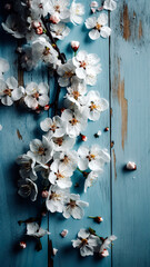Blossoming flowers and stems on a blue wooden background. Wallpaper.