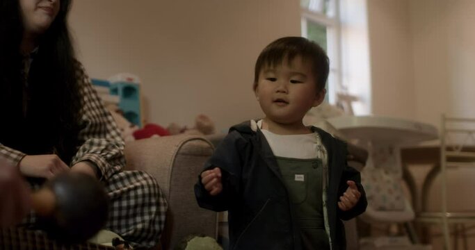 MS Parents and son (18-23 months) playing maracas at home