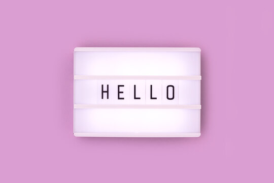 Word Hello. White lightbox with letters on a purple background.
