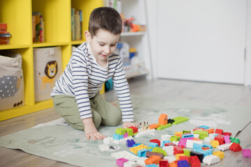 Child playing with colorful toy blocks