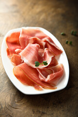 Delicious cured meat on a white plate