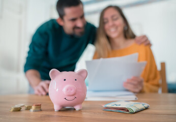 Young family couple managing home finances paying domestic bills satisfied with successful results
