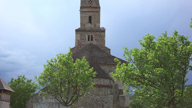 Zoom out of the ancient Densus stone church in Romania