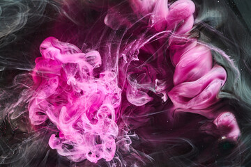 Dark Pink and black abstract ocean background. Splashes, drops and waves of paint under water, clouds of smoke in motion