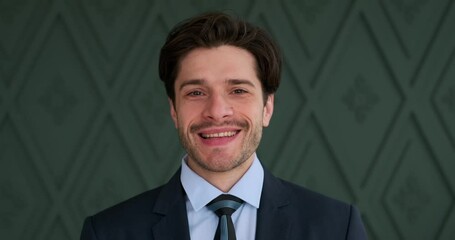 Portrait of handsome businessman getting ready by adjusting necktie in the office