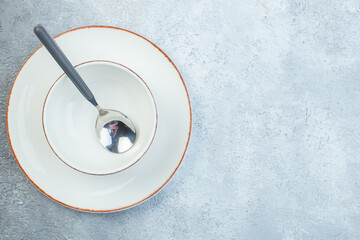 Elegant dinnerware set on isolated gray background with distressed surface with free space