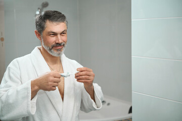 Man getting ready to brush teeth in hostel