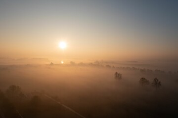 Landscape of the Lek River covered in the fog during the sunrise in Everdingen