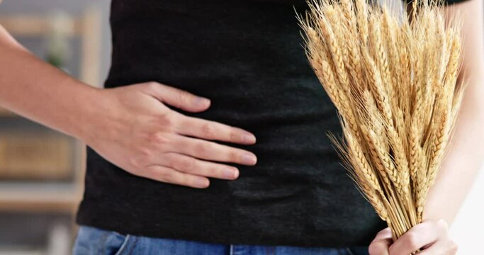 Celiac Disease And Gluten Intolerance. Women Holding Spikelet