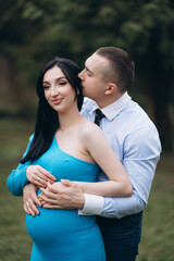 Loving man holding his wife belly over, parenthood concept.