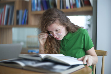 tired overworked girl, exhausted young woman in glasses college or university student is study hard...