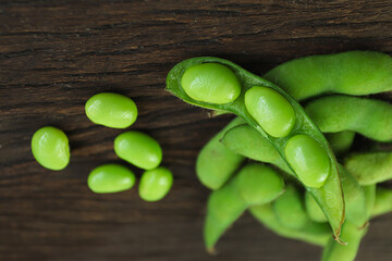 Japanese boiled green soybeans edamame healthy snacks on a wooden background