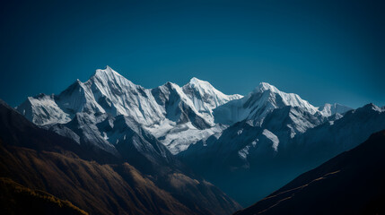 Fototapeta na wymiar A stunning landscape shot of a rocky mountain range against a deep blue sky.