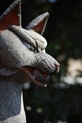 Bronze sculpture of a canine head with blurred background