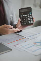 Two businessmen are brainstorming together and reviewing the company financial documents that the finance department has summarized, they are business partners. Business administration concept.