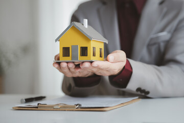 Real estate agents explain models of housing estates in projects to elaborate to clients,...