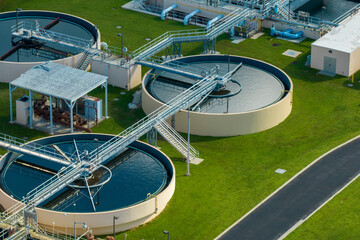 Aerial view of water treatment factory at city wastewater cleaning facility. Purification process of removing undesirable chemicals, suspended solids and gases from contaminated liquid - obrazy, fototapety, plakaty