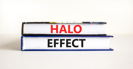 Halo effect and psychological symbol. Concept words Halo effect on beautiful books. Beautiful white table white background. Business psychological and Halo effect concept. Copy space.