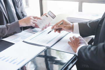 Finance and investment concept, Businessman present business finance investment plan with his partner, Investor colleagues discussing new investment plan by financial graph data on office table