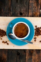 Fototapeta na wymiar Brewed coffee in a glass on a wooden background