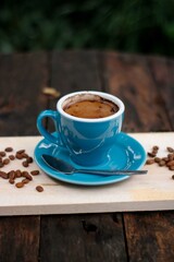 Brewed coffee in a glass on a wooden background