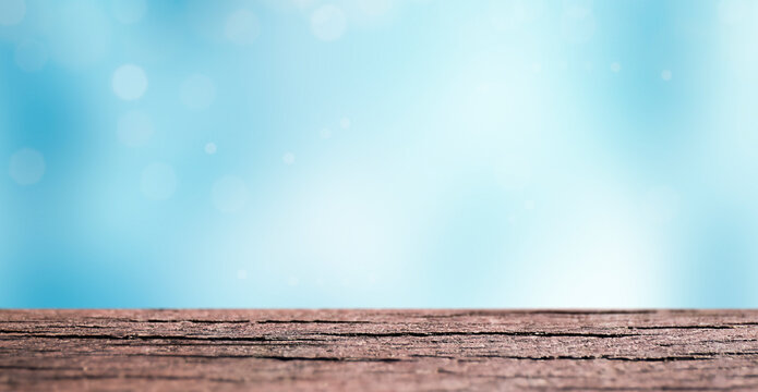 Empty wooden table with defocused blue sky at background. Copy space.