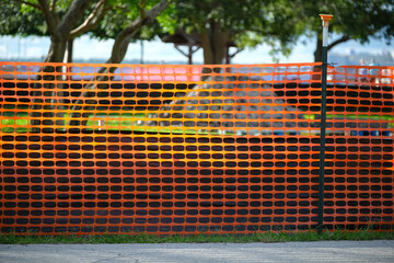 Restriction plastic mesh fence at industrial construction site. Protective barrier for pedestrians...