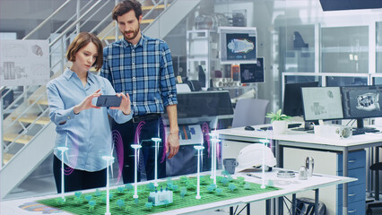 Green Energy Concept: Two Ecological Engineers Use Augmented Reality Smartphone to Design 3D Wind...