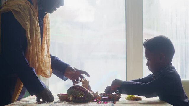 MS Father and son (6-7) preparing decorations for Diwali