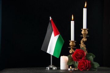 front view of burning candles with palestinian flag on a dark background death israel funeral